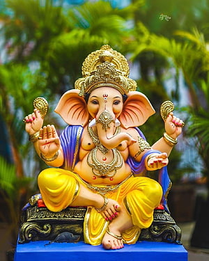 Ornate Ganesha Murti Statue with Golden Crown and Yellow Dhoti HD phone wallpaper