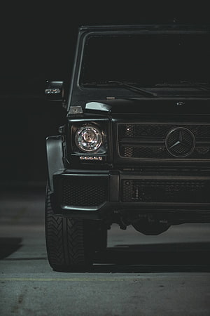 Mercedes-Benz G-Class Front Grille and Headlight Close-Up in Low Light HD phone wallpaper