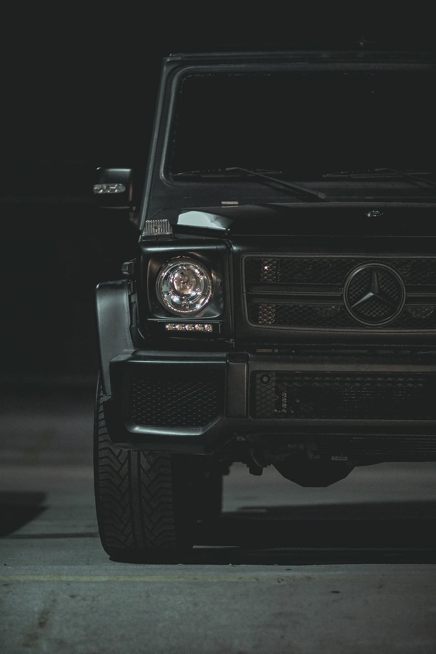 Mercedes-Benz G-Class Front Grille and Headlight Close-Up in Low Light HD phone wallpaper