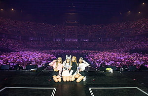 BLACKPINK Kneeling On Stage With Glowing Purple Light Sea At Arena Concert HD wallpaper