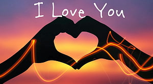 Romantic Hand Silhouette Forming Heart Shape Against Vibrant Sunset Sky HD wallpaper