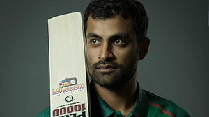 Tamim Iqbal Cricket Portrait Holding Bat in Green Jersey HD wallpaper