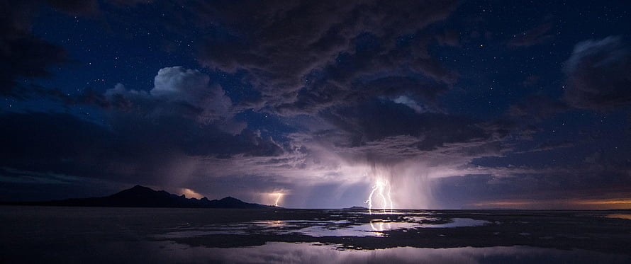 Dramatic Night Lightning Storm Over a Dark Mountain Landscape with Starry Sky HD wallpaper