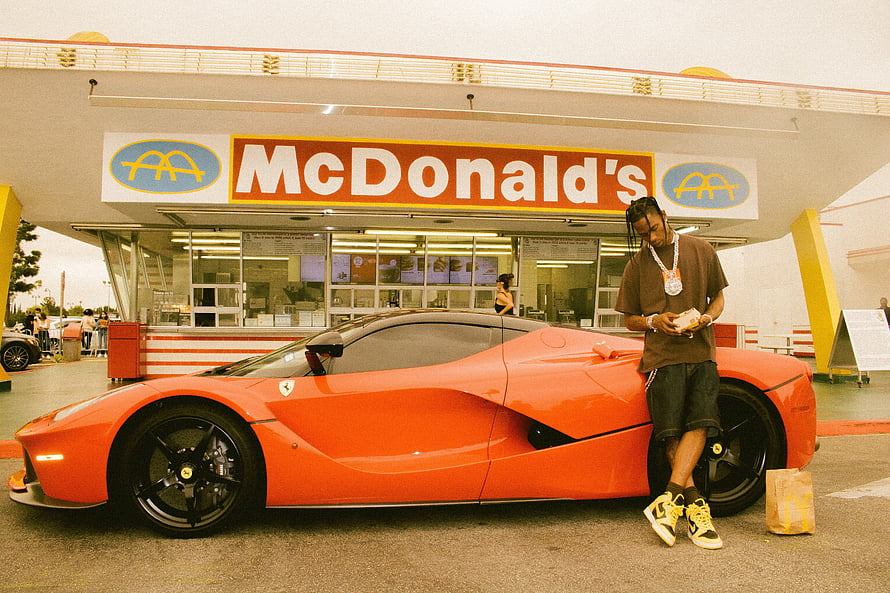Travis Scott Leaning Against Orange Ferrari LaFerrari at McDonald's Drive-Thru HD wallpaper