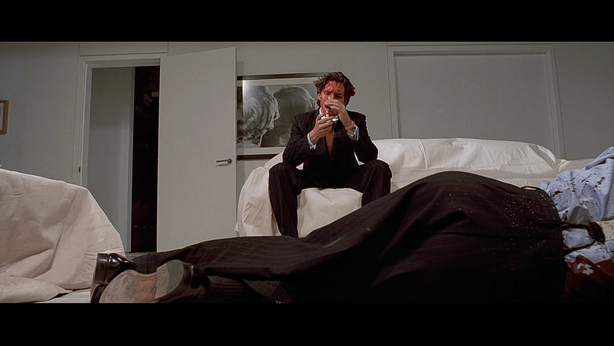 American Psycho Movie Scene of a Bloodied Man in a Suit Sitting on a Bed HD wallpaper