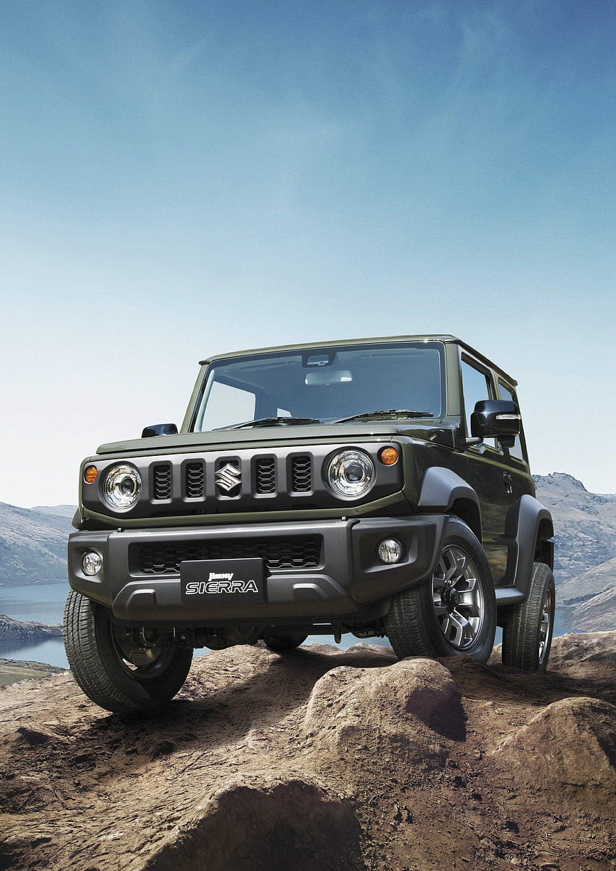 Suzuki Jimny Sierra Off-Road SUV on Rocky Terrain with Mountain Lake Background HD phone wallpaper