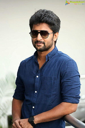 Nani in a navy blue shirt and aviator sunglasses leaning on a railing HD phone wallpaper