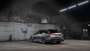 ABT Audi RS6 Avant Performance Wagon in Industrial Garage Setting HD wallpaper