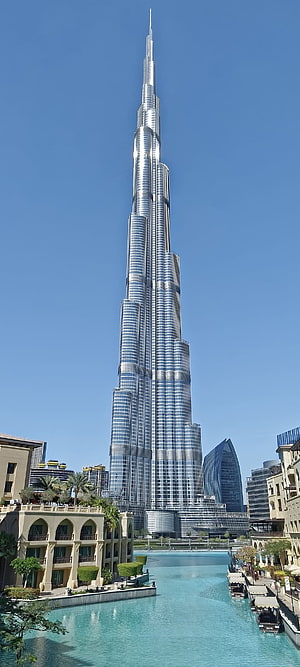 Burj Khalifa Tower Rising Over Dubai Canal With Clear Blue Sky HD phone wallpaper