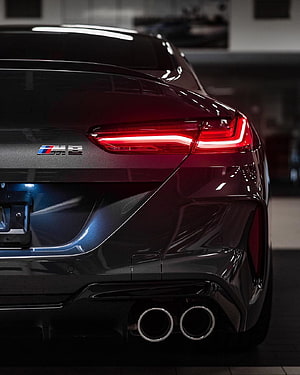 Rear Detail of a Black BMW M8 Coupe Featuring LED Taillights and Dual Exhaust Tips HD phone wallpaper