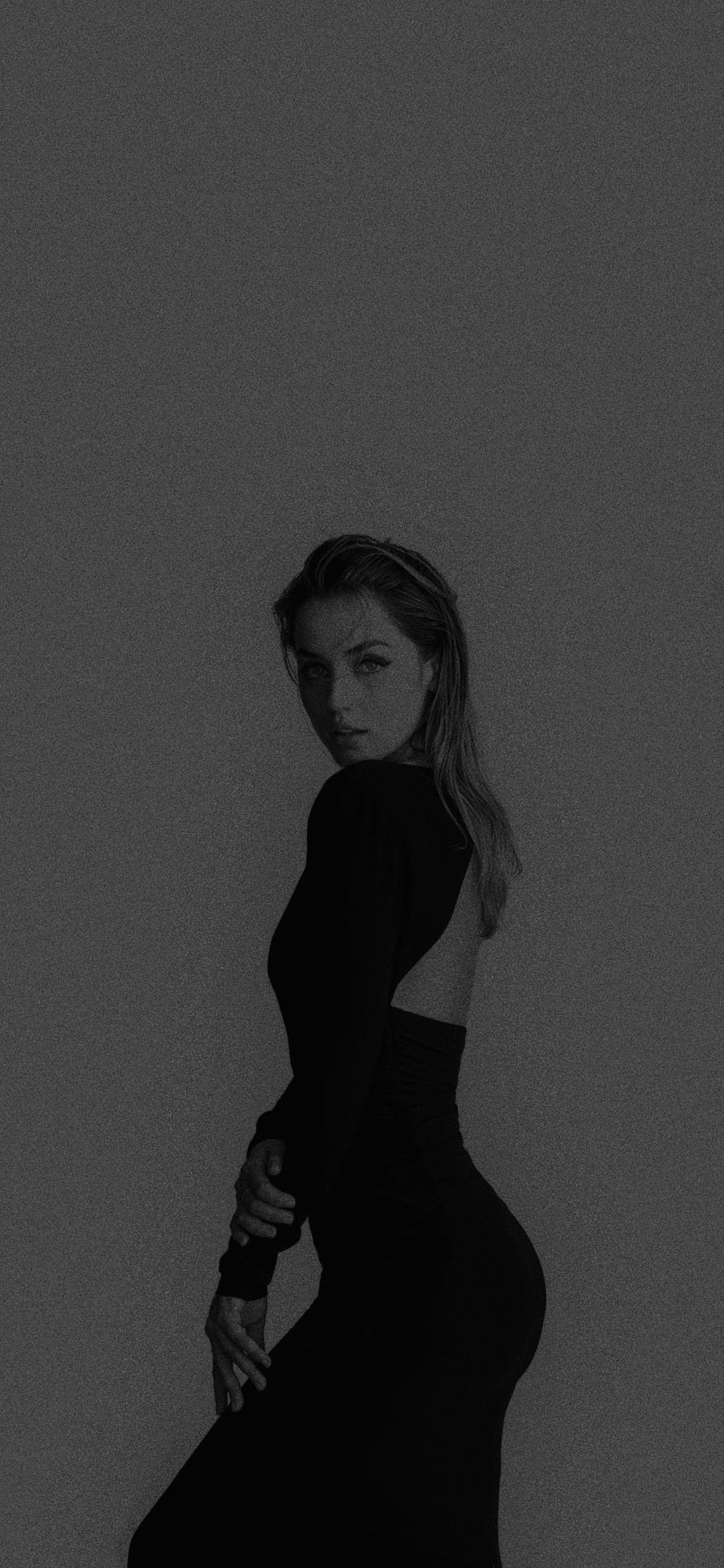 Ana de Armas in a black backless dress, moody studio portrait with dramatic side lighting HD phone wallpaper