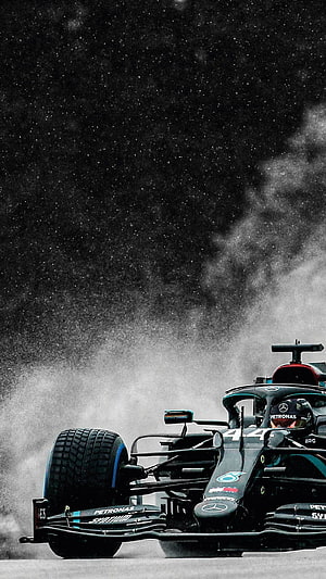 Mercedes F1 W11 race car kicking up spray on a wet track with Lewis Hamilton at the wheel HD phone wallpaper