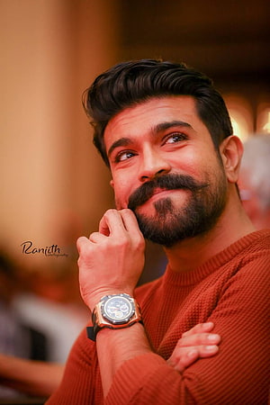 Ram Charan Portrait in Rust Orange Sweater with Watch and Beard HD phone wallpaper