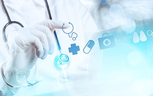 Gloved hand interacting with floating medical icons and stethoscope in a bright clinical setting HD wallpaper