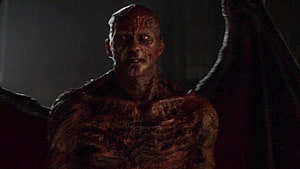 Lucifer Demon Character with Glowing Red Eyes and Burned Skin in Dark Cinematic Scene HD wallpaper