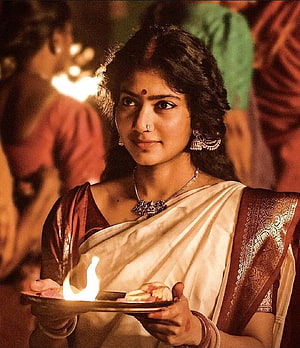 Sai Pallavi as Shyam Singha Roy Holding a Traditional Oil Lamp During a Festival HD phone wallpaper