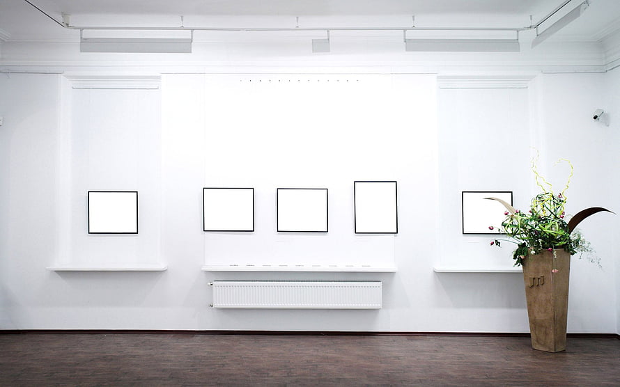 Minimalist White Gallery Interior With Framed Art and Floral Arrangement HD wallpaper