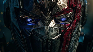 Optimus Prime Close-Up Portrait with Glowing Blue Eyes and Battle Damage HD wallpaper