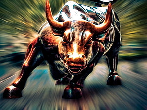 Dynamic Bronze Bull Statue Charging Forward With Dramatic Motion Blur Background HD wallpaper