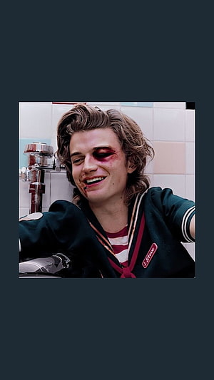 Steve Harrington from Stranger Things with a bruised eye and a grin in a tiled bathroom HD phone wallpaper
