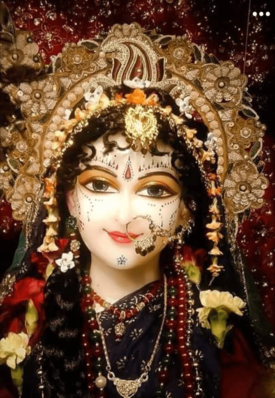 Ornate Radha Rani Murti with Traditional Indian Jewelry and Floral Garland HD phone wallpaper