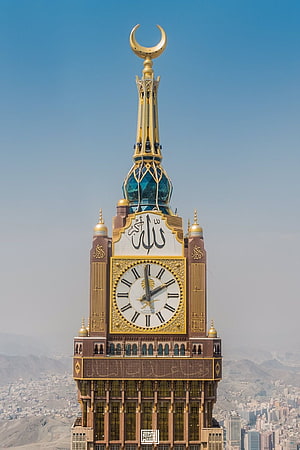 Makkah Royal Clock Tower with Golden Crescent and Arabic Calligraphy Against Clear Blue Sky HD phone wallpaper