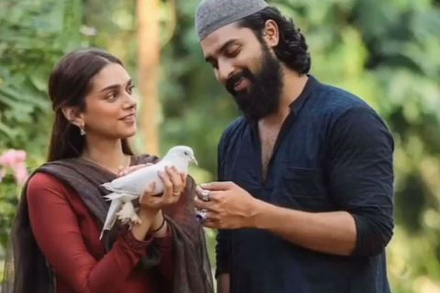 Sufiyum Sujatayum Movie Still Featuring Couple With White Dove in Garden HD wallpaper