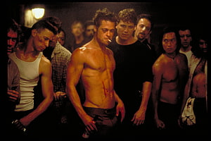 Brad Pitt as Tyler Durden in Fight Club cinematic still with shirtless men in dim lighting HD wallpaper