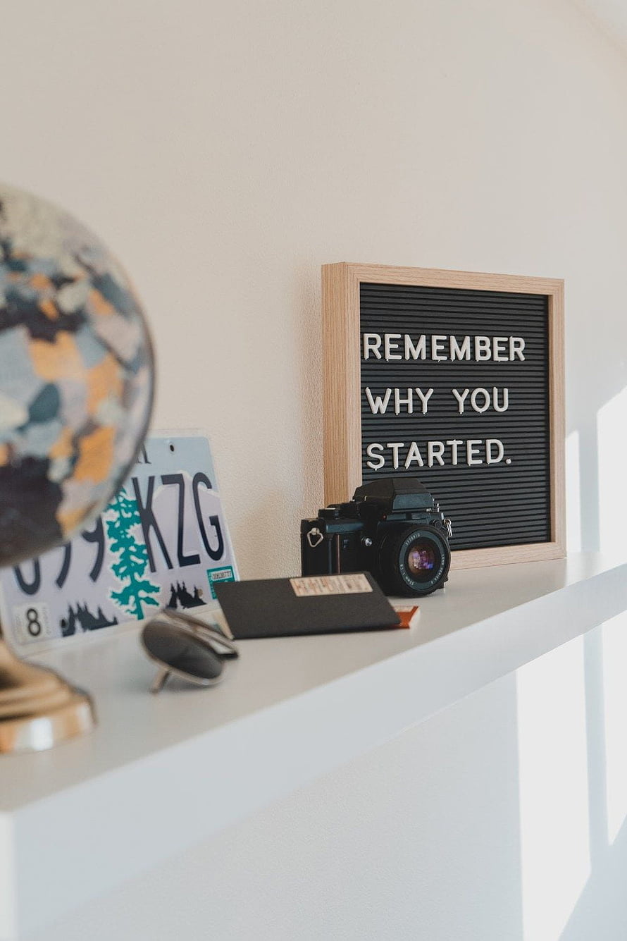 Minimalist Desk Setup With Vintage Camera, Globe, and Motivational Letter Board HD phone wallpaper