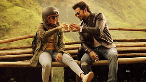 Ritika Singh and Vani Bhojan sharing a moment on a bamboo bridge in Oh My Kadavule HD wallpaper