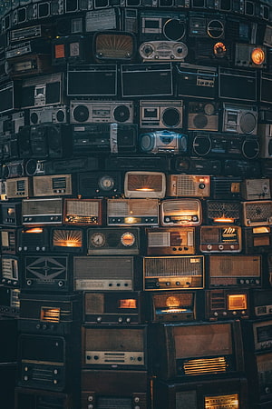 Wall of Vintage Radios and Retro Boomboxes in Moody Low Light HD phone wallpaper
