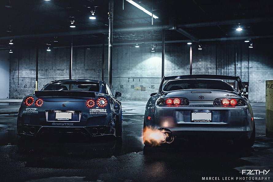 Nissan GT-R and Toyota Supra Rear View in Dark Parking Garage HD wallpaper