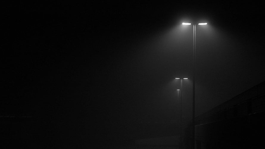 Moody Street Lights Cutting Through Thick Fog on a Dark Urban Road at Night HD wallpaper
