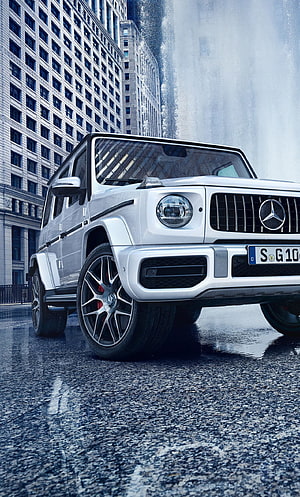 White Mercedes G-Class SUV on Wet City Street with Modern Architecture HD phone wallpaper