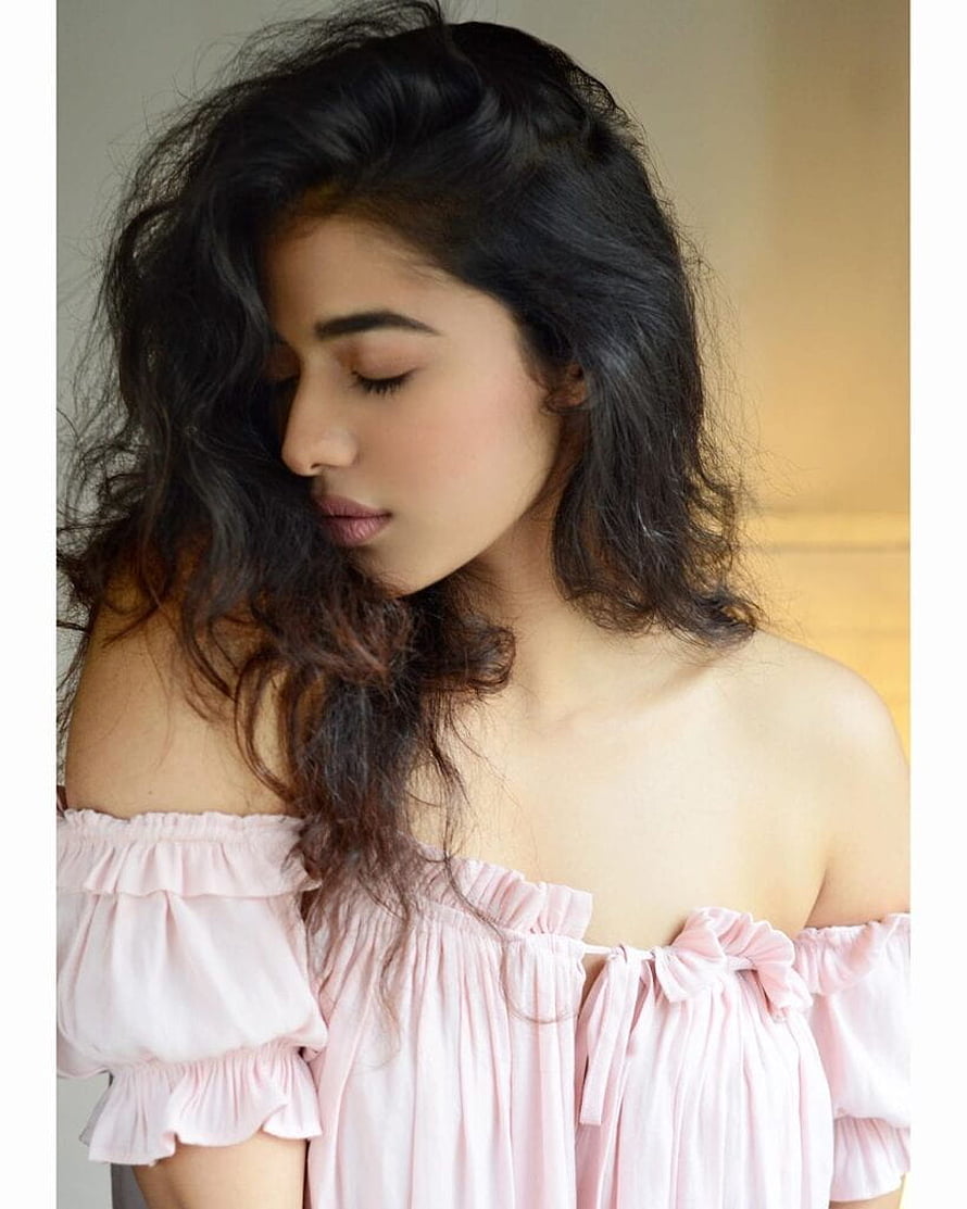 Kethika Sharma in a soft pink off-shoulder ruffled top with long wavy dark hair HD phone wallpaper