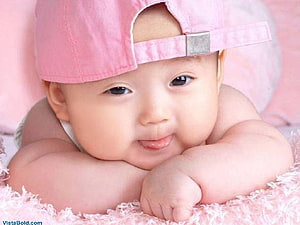 Adorable Baby Wearing a Pink Baseball Cap Lying on a Soft Blanket HD wallpaper