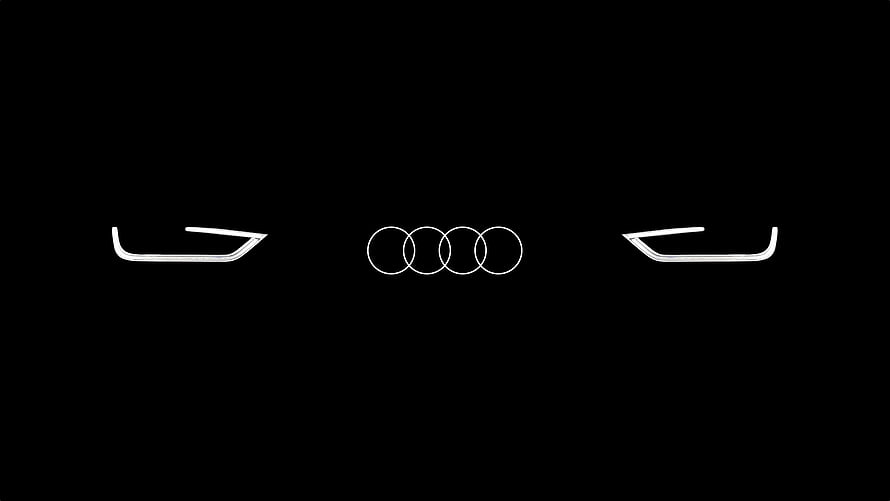 Audi Four Rings Emblem with Sleek Headlight Design on Black Background HD wallpaper
