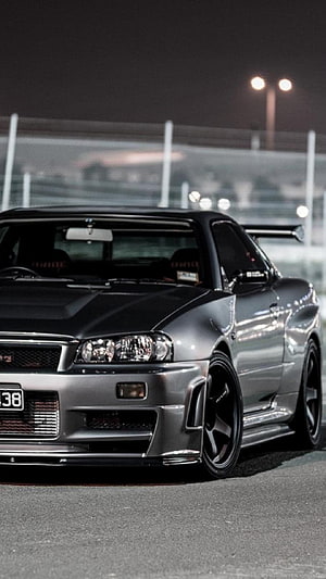 Nissan Skyline R34 GT-R Night Street Scene with Widebody Kit and Custom Wheels HD phone wallpaper