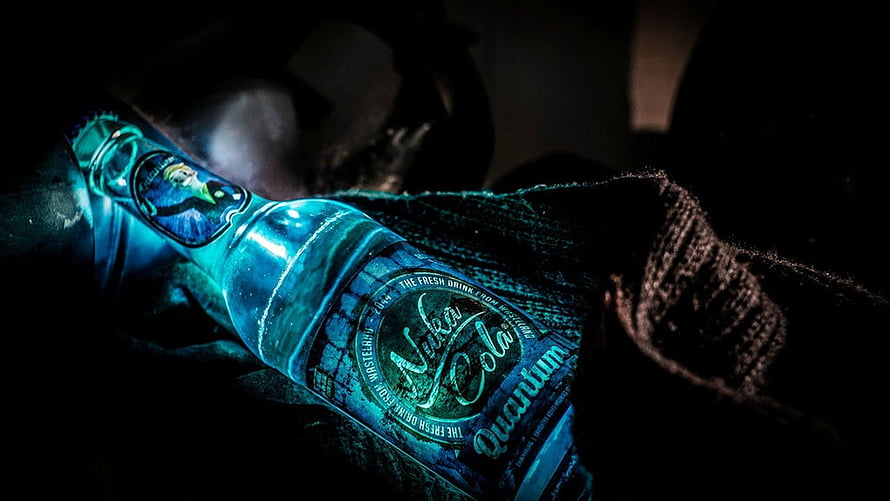 Nokia Cola Glass Bottle with Cyan Neon Glow on Dark Textured Surface HD wallpaper