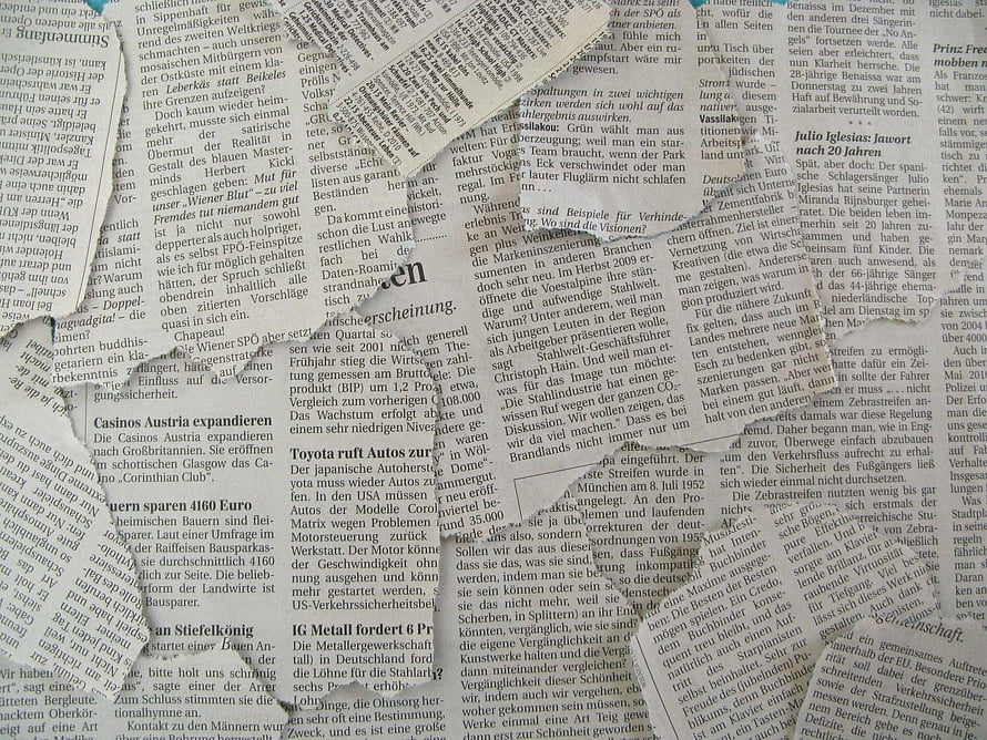 Vintage German Newspaper Collage with Torn Paper Texture and Headlines HD wallpaper