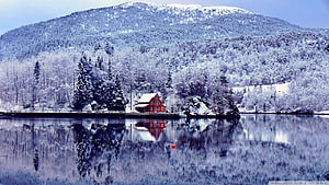 Red Lakeside Cottage in Snowy Winter Landscape with Mountain Reflection HD wallpaper