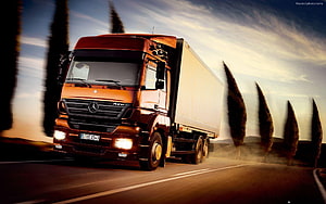 Mercedes-Benz Actros Semi-Truck Hauling Cargo on a Scenic Highway at Sunset HD wallpaper
