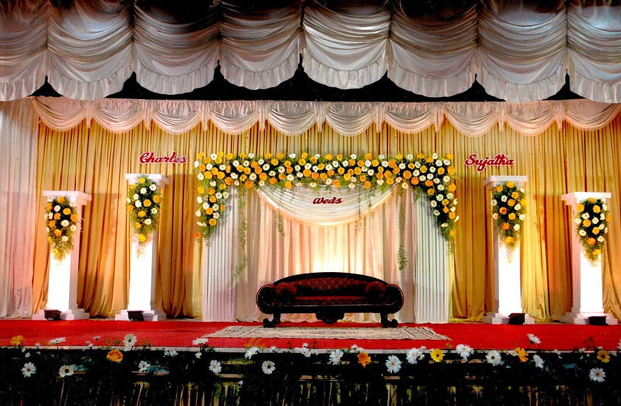 Indian Wedding Stage Decor With Floral Arch, Draped Curtains, and Red Velvet Sofa HD wallpaper