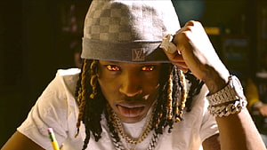 King Von Wearing Louis Vuitton Cap and Gold Chains in Dramatic Portrait HD wallpaper