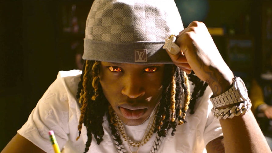 King Von Wearing Louis Vuitton Cap and Gold Chains in Dramatic Portrait HD wallpaper