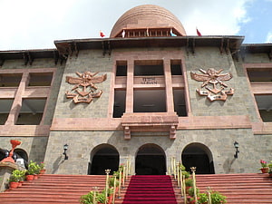 National Defence Academy Building Facade with Red Carpet and Eagle Emblems HD wallpaper