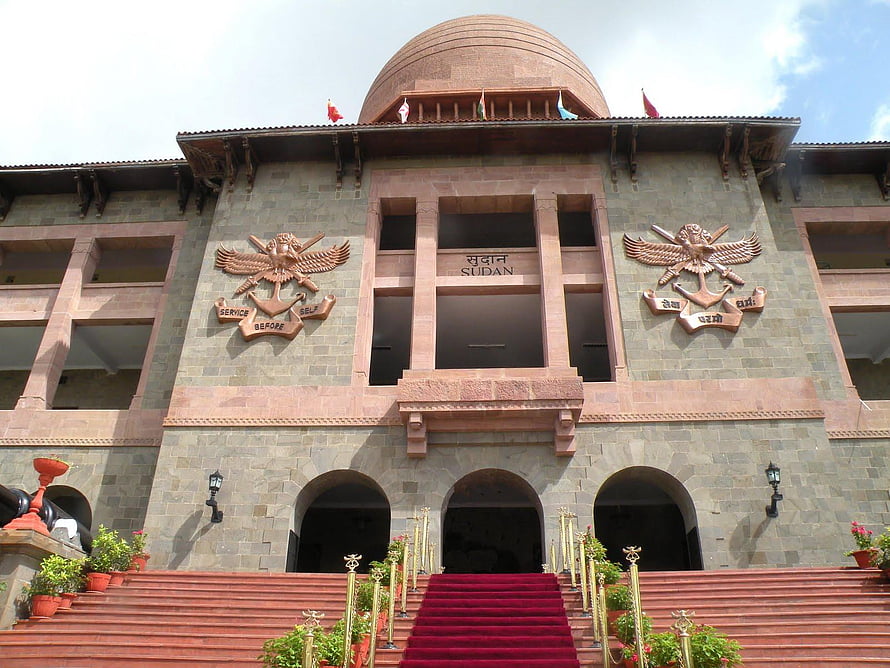 National Defence Academy Building Facade with Red Carpet and Eagle Emblems HD wallpaper