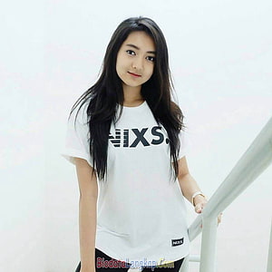 Young woman with long dark hair wearing a white graphic t-shirt standing by a railing, 35 Foto Cewek Cantik Indonesia Idaman Para Cowok, cewe cantik HD phone wallpaper