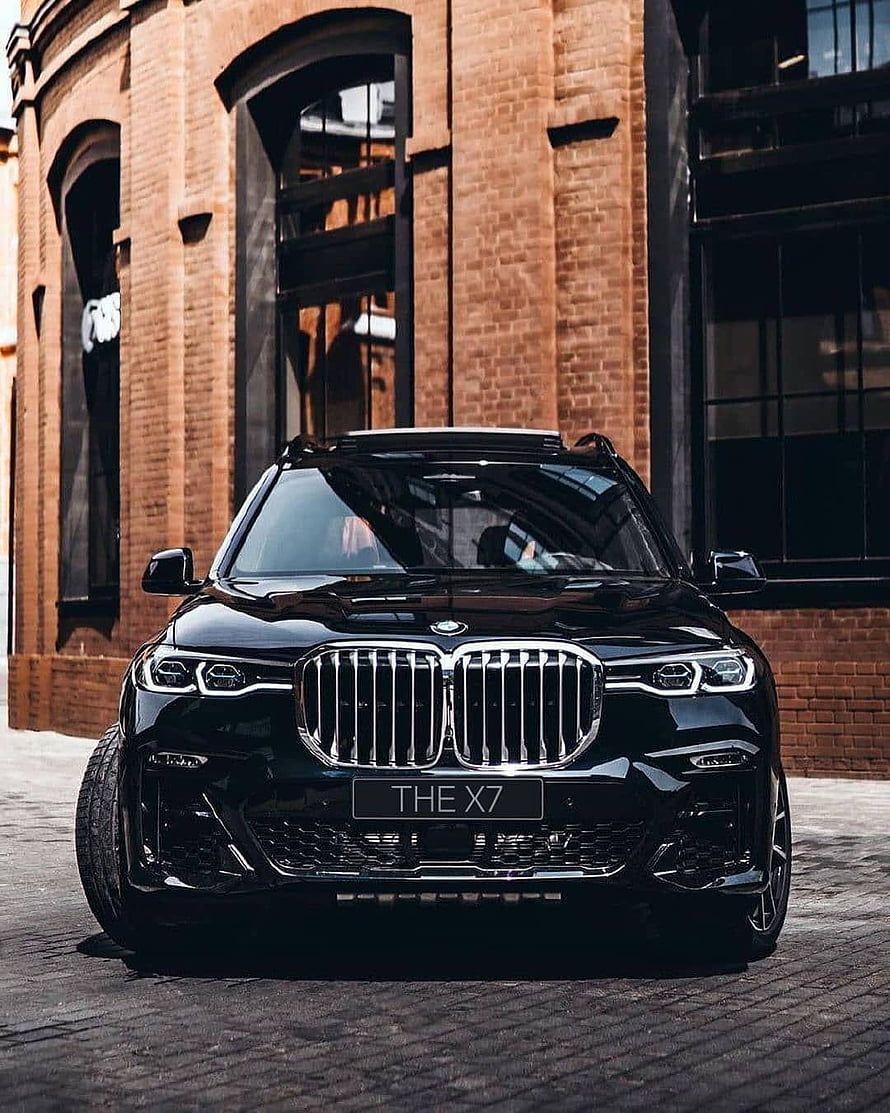 Black BMW X7 M50i Front View Parked in Front of Brick Building HD phone wallpaper