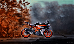 KTM RC 390 Sport Motorcycle in Orange and Black on a Wet Urban Street HD wallpaper
